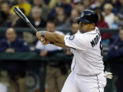 Seattle Mariners' Kendrys Morales hits a run-scoring single against the Houston Astros in the first inning Monday.