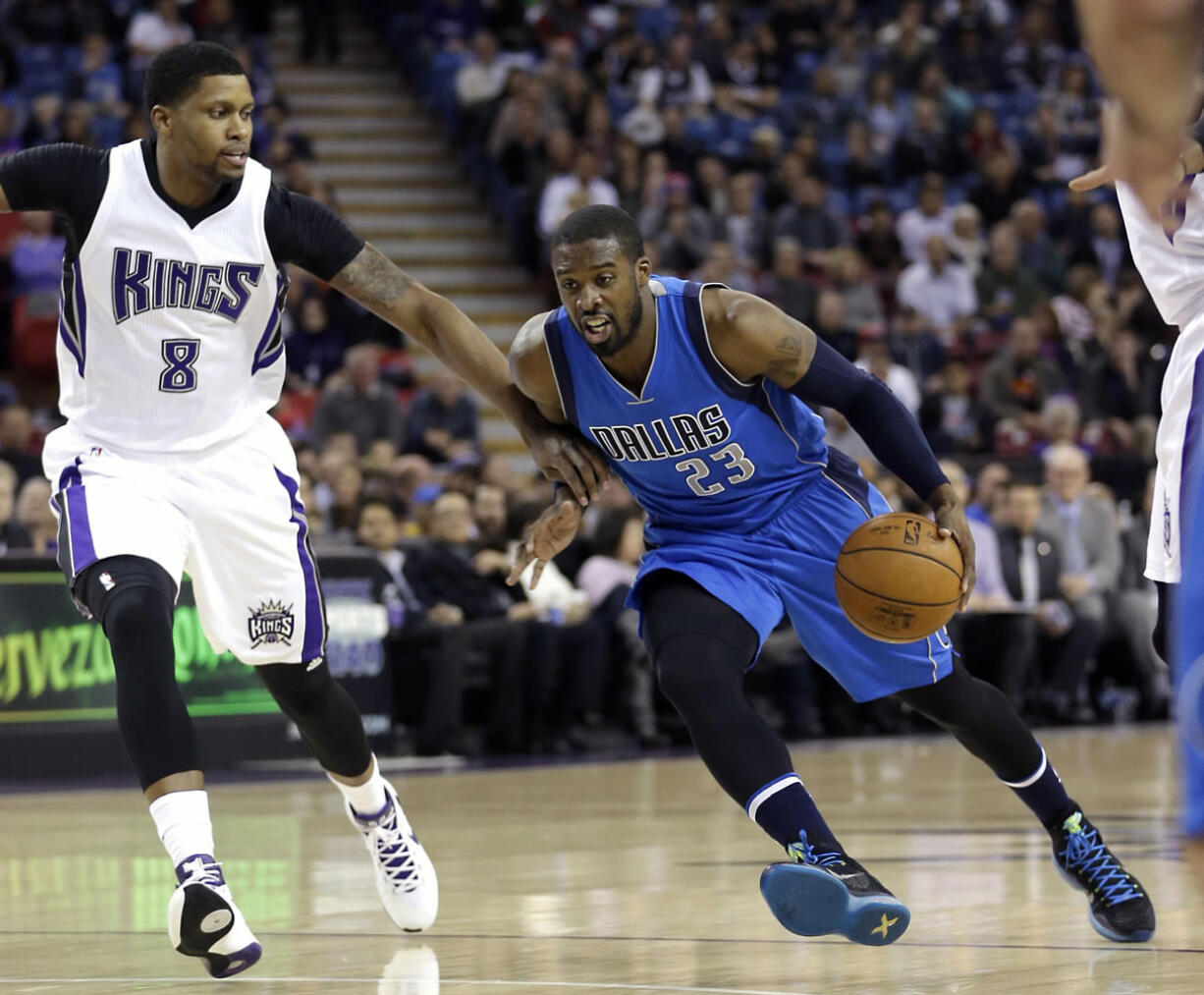 Dallas Mavericks guard Wesley Matthews, right, drives against Sacramento Kings forward Rudy Gay during the first quarter of an NBA basketball game in Sacramento, Calif., Monday, Nov. 30, 2015.