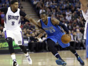 Dallas Mavericks guard Wesley Matthews, right, drives against Sacramento Kings forward Rudy Gay during the first quarter of an NBA basketball game in Sacramento, Calif., Monday, Nov. 30, 2015.