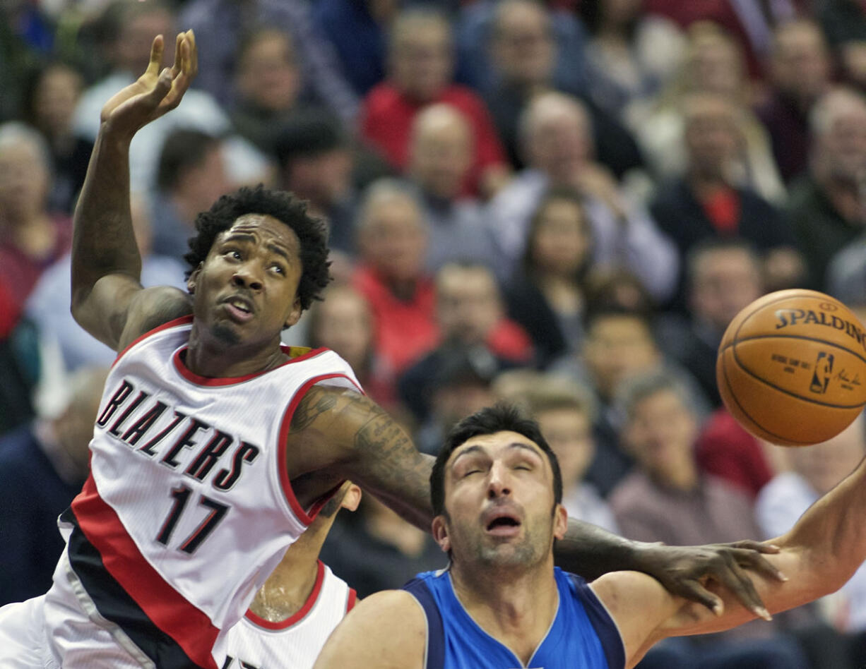 Portland Trail Blazers center Ed Davis (17) fouls Dallas Mavericks center Zaza Pachulia during the first half of an NBA basketball game in Portland, Ore., Tuesday, Dec. 1, 2015.