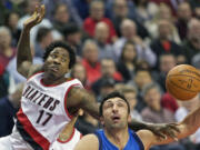 Portland Trail Blazers center Ed Davis (17) fouls Dallas Mavericks center Zaza Pachulia during the first half of an NBA basketball game in Portland, Ore., Tuesday, Dec. 1, 2015.