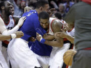 Portland Trail Blazers forward LaMarcus Aldridge, right, is mobbed by teammates after sinking a shot at the buzzer against the Dallas Mavericks on Tuesday.