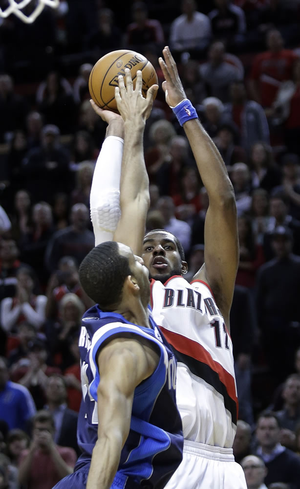 Portland Trail Blazers forward LaMarcus Aldridge, right, shoots over Dallas Mavericks forward Brandan Wright just before the buzzer to win Tuesday's game.