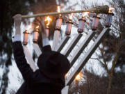 Rabbi Shmulik Greenberg of Chabad Lubavitch of Clark County, lights the Menorah during a Chanukah Celebration at Esther Short Park in 2008.