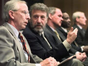 George Zimmer, second from left, speaks with Andy Dolich prior to a 1999 meeting in Oakland, Calif.