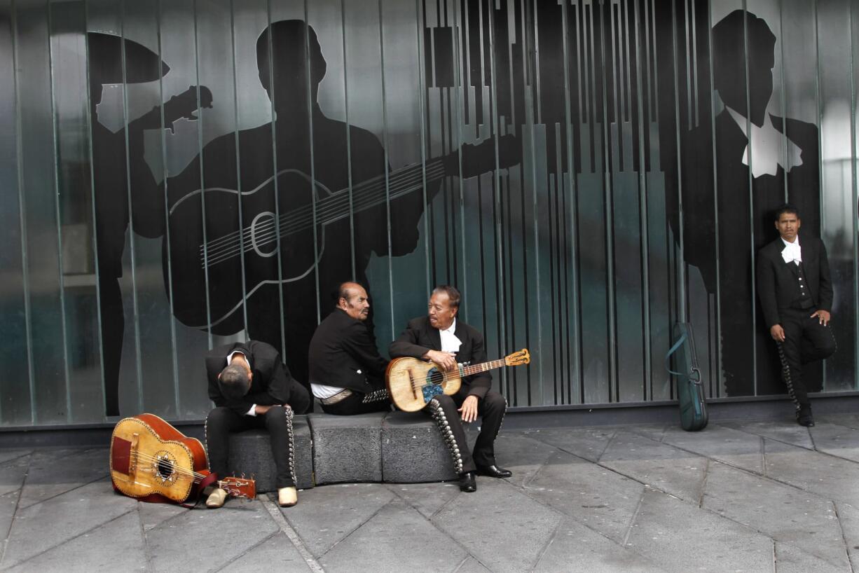 Mariachi musicians sit in Garibaldi Plaza in City Mexico City on Friday. Malcolm Shabazz, 28, the grandson of political activist Malcolm X, died in Mexico, U.S.