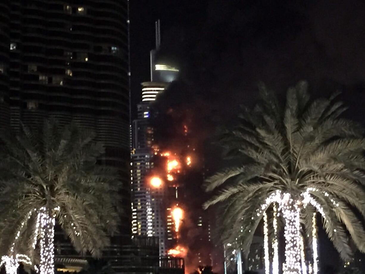 A fire runs up some 20 stories of a building in Dubai, United Arab Emirates, Thursday, Dec. 31, 2015. The fire broke out Thursday in a residential building near Dubai's massive New Year's Eve fireworks display. It was not immediately clear what caused the fire near the Burj Khalifa, the world's tallest skyscraper at 828 meters (905 yards).