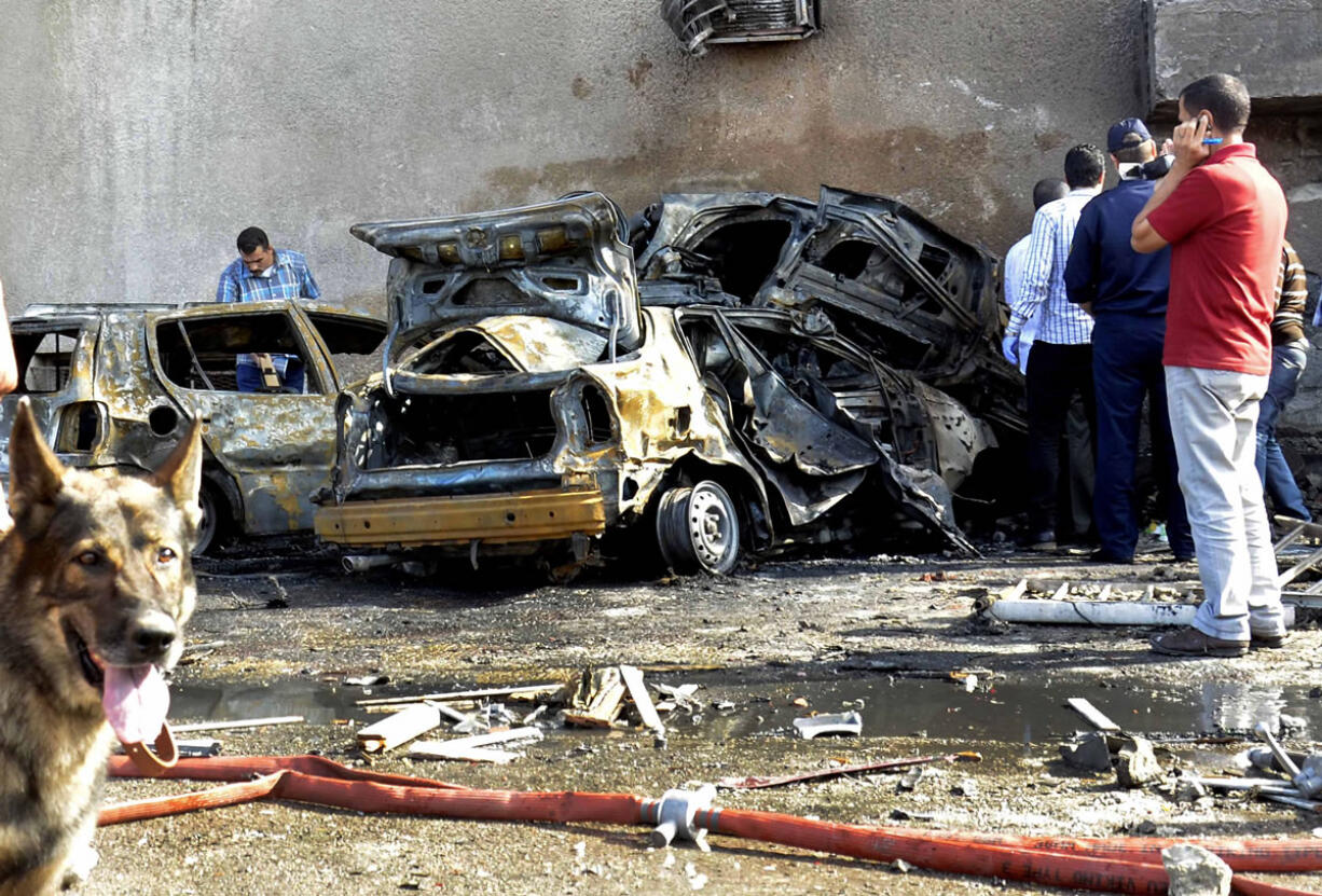 Security officials examine the site of a car bomb in the Suez Canal city of Ismailia, Egypt, Saturday Oct. 19, 2013.