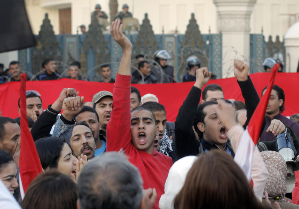 Egyptian protesters shout slogans against President Mohammed Morsi  in front of the presidential palace in Cairo, Egypt, Friday, Jan.25, 2013. Two years after Egypt's revolution began, the country's schism was on display Friday as the mainly liberal and secular opposition held rallies saying the goals of the pro-democracy uprising have not been met and denouncing Islamist President Mohammed Morsi.