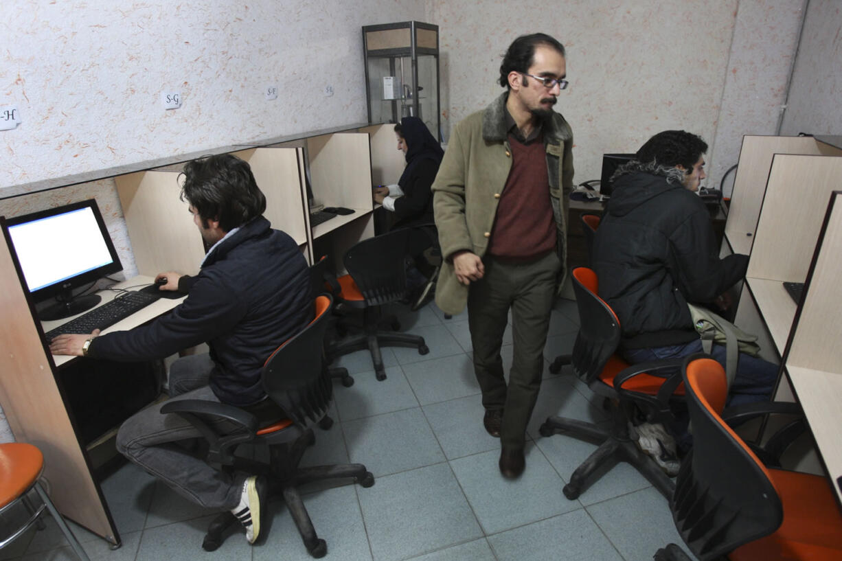 Iranians use internet in an internet cafe in central Tehran, Iran, in 2001.