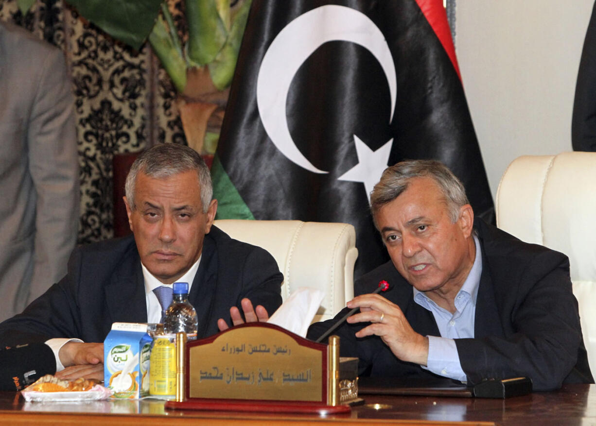 Libyan Prime Minister Ali Zidan, left, gives a press conference after being rescued from gunmen who snatched him from his hotel early Thursday and held him for several hours, in Tripoli Libya on Thursday. The brazen abduction, which ended with Zidan's rescue, underscored the lawlessness gripping Libya two years after the ouster of autocrat Moammar Gadhafi.