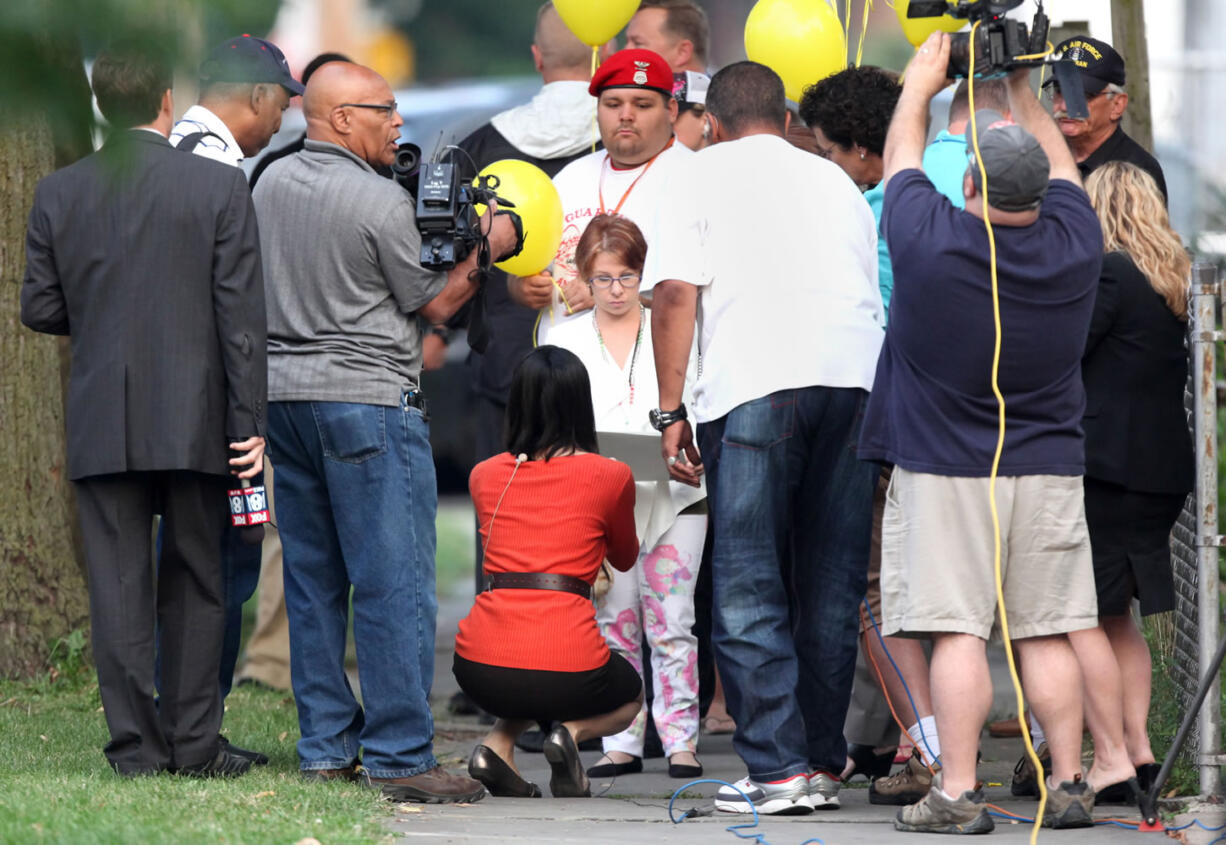 Michelle Knight arrives at Ariel Castro's  home in Cleveland on Wednesday. Castro held Knight, Amanda Berry and Gina DeJesus captive for nearly a decade at this property. The house was torn down as part of a deal that spared Ariel Castro a possible death sentence.