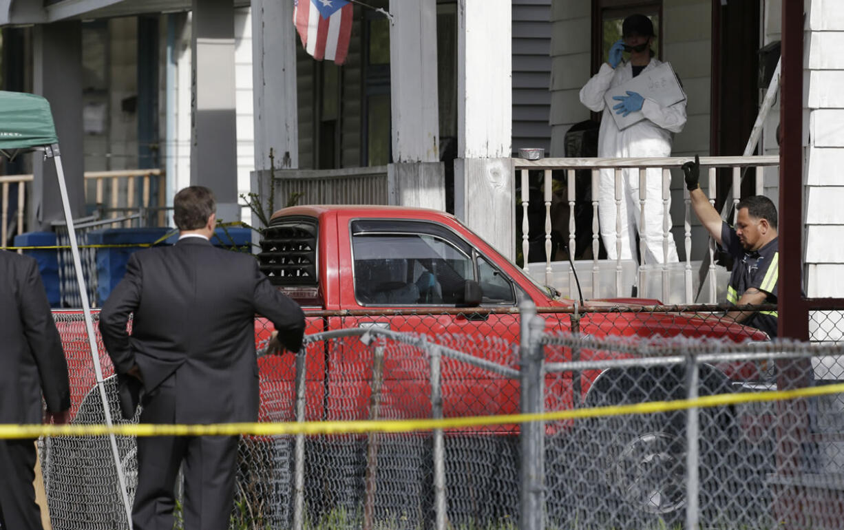 A truck is pulled out a driveway from a house Tuesday where three women who vanished a decade ago were held, in Cleveland.