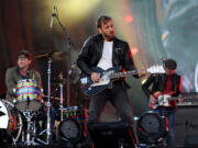 FILE - In this Sept. 29, 2012 file photo, guitarist Dan Auerbach, center, and drummer Patrick Carney of The Black Keys perform at the Global Citizen Festival in Central Park, in New York.