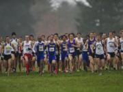 Runners take off at the starting gun for the men's race at the NAIA Cross Country National Championships on Saturday, Nov.