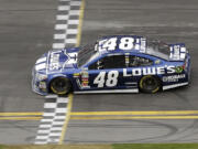 Jimmie Johnson crosses the finish line to win the Daytona 500 on Sunday.