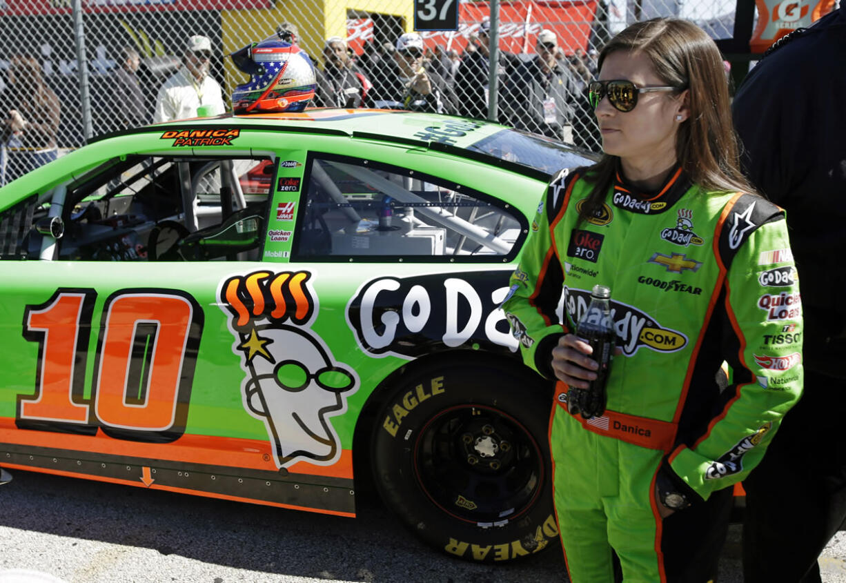 Danica Patrick stands by her car after qualifying for the NASCAR Daytona 500 at Daytona International Speedway, Sunday, Feb. 17, 2013, in Daytona Beach, Fla.