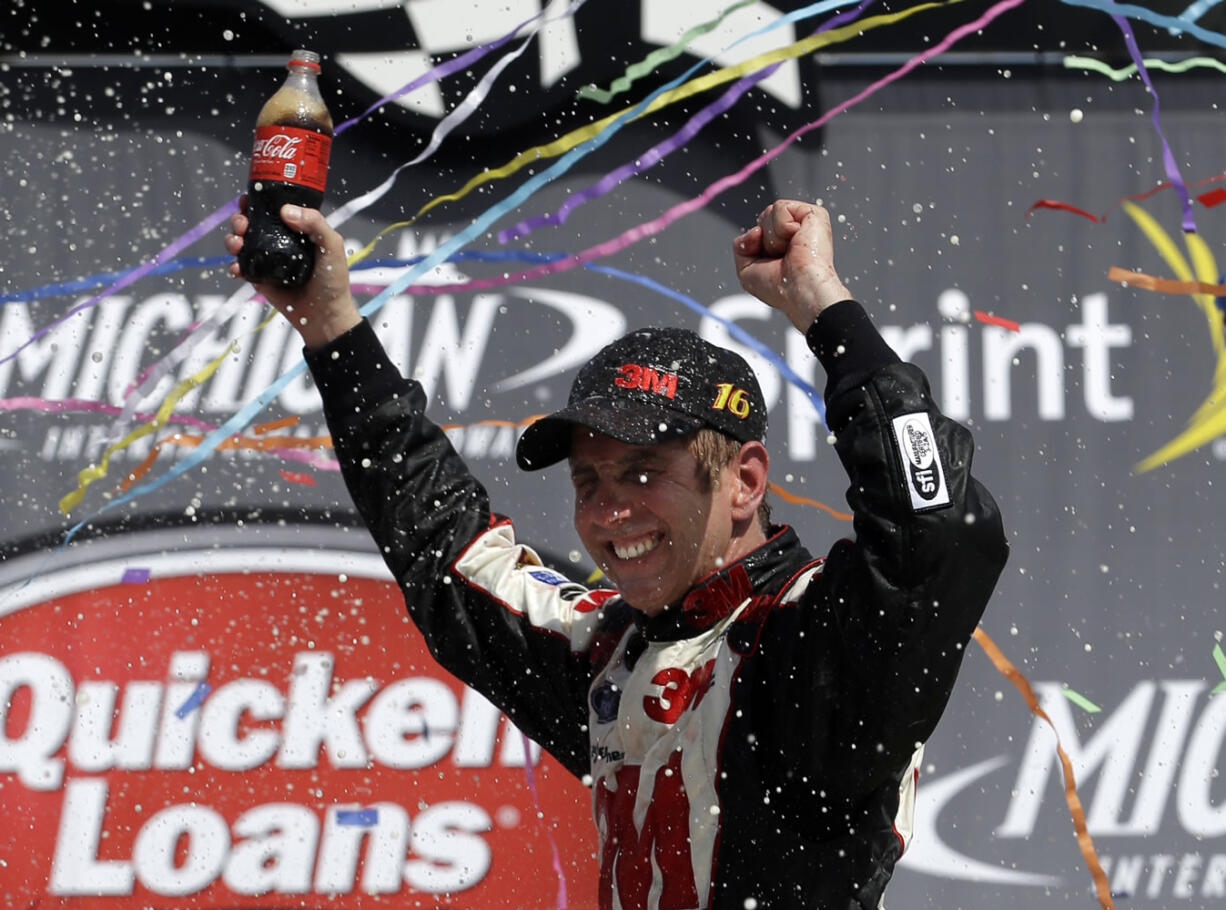 Clark County native Greg Biffle celebrates his win in the NASCAR Quicken Loans 400 auto race at Michigan International Speedway on Sunday.