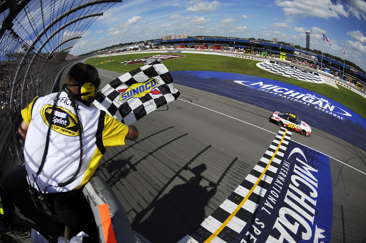 Greg Biffle takes the checkered flag to win the Quicken Loans 400 at Michigan International Speedway on Sunday.