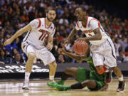 Louisville guard Russ Smith (2) dribbles after stealing the ball from Oregon guard Damyean Dotson during the second half Friday.