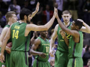 ben margot/The Associated Press
From left, Oregon's E.J. Singler, Arsalan Kazemi (14), Jonathan Loyd (10), Ben Carter and Dominic Artis celebrate on the court during the second half of the No. 12 seed Ducks' win over No. 5 seed Oklahoma State.