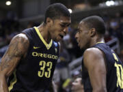 Oregon's Carlos Emory, left, and Johnathan Loyd celebrate the Ducks' 74-57 victory over Saint Louis on Saturday.