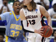 Gonzaga's Kelly Olynyk, right, looks to pass as Southern University's Malcolm Miller defends in the first half Thursday.