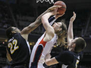 Gonzaga's Kelly Olynyk, center, is sandwiched between Wichita State's Carl Hall, left and Demetric Willimas during the first half Saturday.