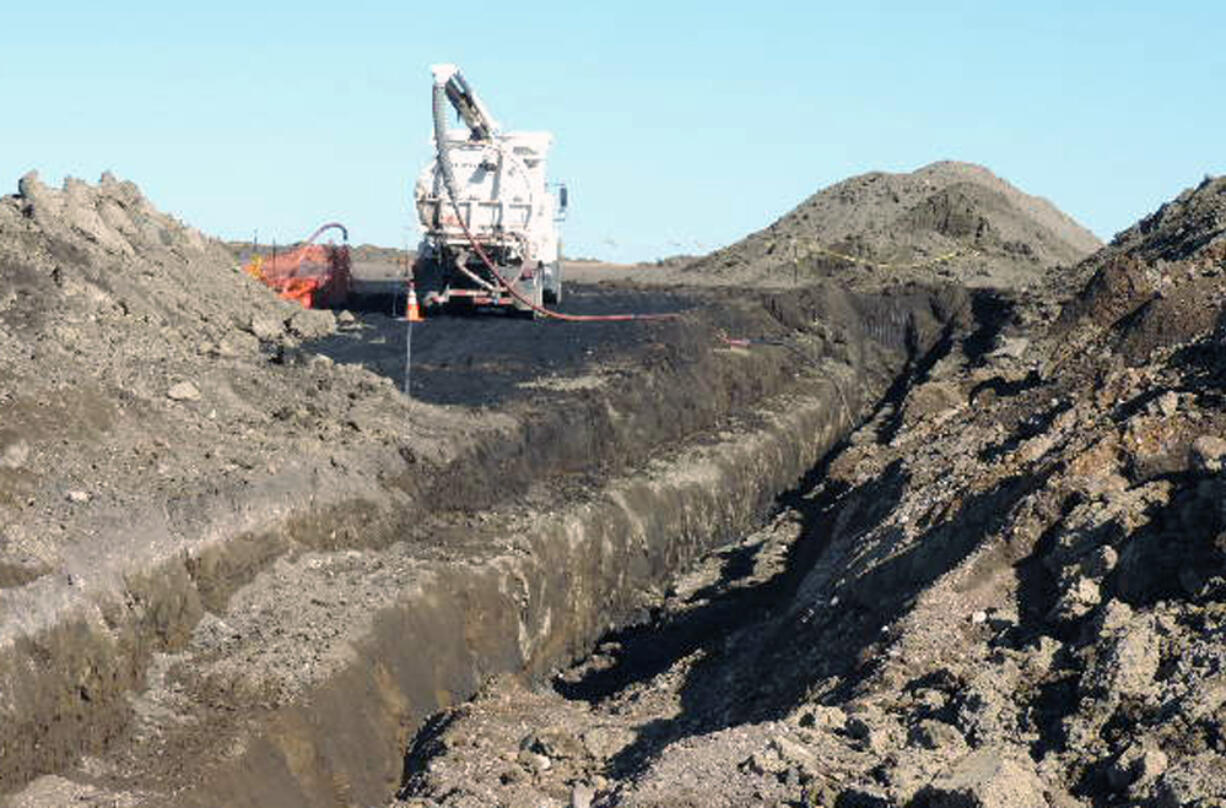 A vacuum trucks cleans up oil in near Tioga, N.D. on Oct. 8. The North Dakota Health Department says more than 20,000 barrels of crude oil have spewed out of a Tesoro Corp. oil pipeline in a wheat field in northwestern North Dakota. Officials say the 20,600-barrel spill, among the largest recorded in the state, was discovered on Sept.