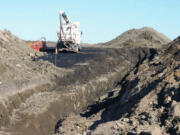 A vacuum trucks cleans up oil in near Tioga, N.D. on Oct. 8. The North Dakota Health Department says more than 20,000 barrels of crude oil have spewed out of a Tesoro Corp. oil pipeline in a wheat field in northwestern North Dakota. Officials say the 20,600-barrel spill, among the largest recorded in the state, was discovered on Sept.