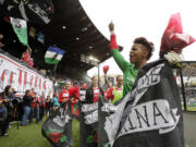 Portland Thorns goalie Karina LeBlanc, right, celebrates with teammates and fans after their National Women's Soccer League 2-1 victory over the Seattle Reign on Sunday.