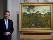 Van Gogh Museum director Axel Rueger, left, looks at &quot;Sunset at Montmajour&quot; after unveiling the painting by Dutch painter Vincent van Gogh during a press conference at the museum in Amsterdam, Netherlands, on Monday. The museum has identified the long-lost painting which was painted by the Dutch mater in 1888, the discovery is the first full size canvas that has been found since 1928 and will be on display from Sept.