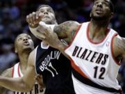 LaMarcus Aldridge (12), tangling with the Nets' Brook Lopez, could miss his third consecutive game due to an ankle injury.