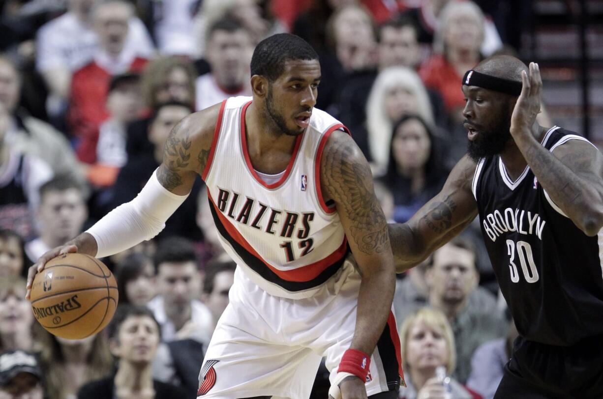 Portland's LaMarcus Aldridge, left, looks to maneuver against Brooklyn Nets forward Reggie Evans.