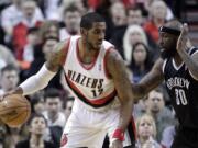 Portland's LaMarcus Aldridge, left, looks to maneuver against Brooklyn Nets forward Reggie Evans.