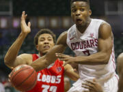 Washington State guard Ike Iroegbu (2) passes off the basketball while being defended by New Mexico forward Tim Williams (32) in the second half of an NCAA college basketball game at the Diamond Head Classic, Friday, Dec. 25, 2015, in Honolulu. Washington State won 82-59.