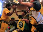 Supporters of the new arena plan, from left, Kris Brannon, Jason Billingsley, Joseph Chong, Dawn Welch and Kenneth Knutsen, celebrate after the Seattle City Council voted to accept Chris Hansen's plan to build a new $490 million arena with $200 million in public bonds on Monday in Seattle.