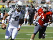 Oregon's quarterback Marcus Mariotta (8) runs against Nicholls State Ryan Bruno (43) during the first half Saturday.