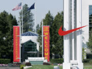 The red Nike swoosh marks the entrance to the company's headquarters campus in Beaverton, Ore.