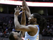 Nuggets forward Kenneth Faried, right, shoots over Trail Blazers guard Wesley Matthews during Portland's win on Thursday.