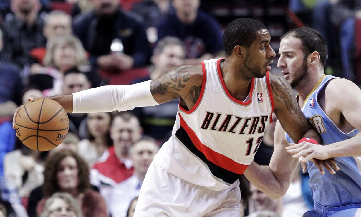 Don Ryan/The Associated Press
Portland Trail Blazers forward LaMarcus Aldridge, left, works the ball inside against Denver Nuggets center Kosta Koufos.