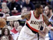 Don Ryan/The Associated Press
Portland Trail Blazers forward LaMarcus Aldridge, left, works the ball inside against Denver Nuggets center Kosta Koufos.