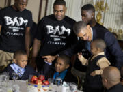 President Barack Obama greets guests, including fathers and their children participants in the Becoming a Man (BAM) program at Hyde Park Academy in Chicago, on Friday  in the State Dining Room of the White House in Washington, where the president hosted a Father's Day luncheon.