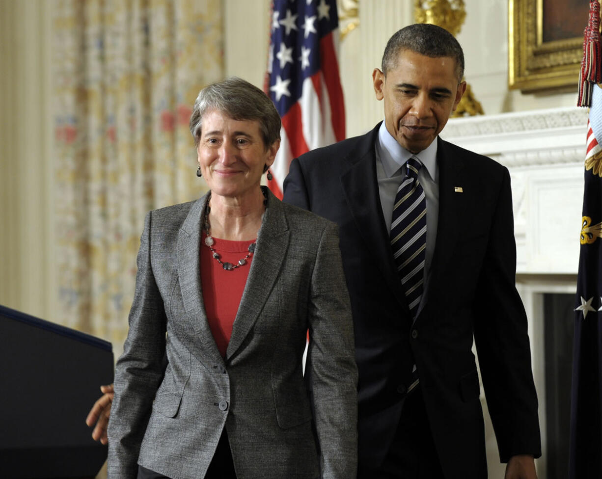 President Barack Obama walks with Interior Secretary-designate REI Chief Executive Officer Sally Jewell following the announcement Wednesday in the State Dining Room of the White House in Washington.