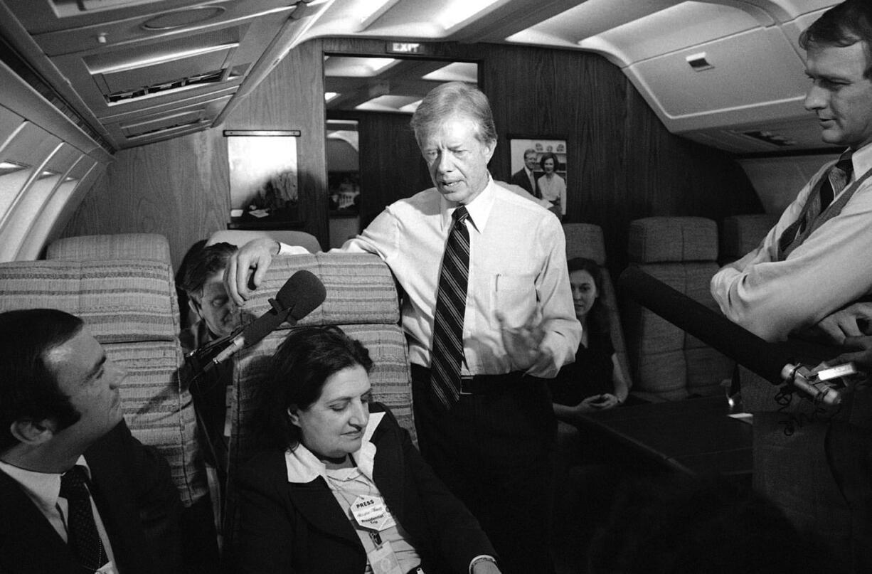 President Jimmy Carter and press secretary Jody Powell, right, talk with reporters Helen Thomas, center, and Sam Donaldson, left, while aboard Air Force One prior on Oct. 20, 1979 to landing at Andrews Air Force Base, Md. Thomas, a pioneer for women in journalism and an irrepressible White House correspondent, has died Saturday.