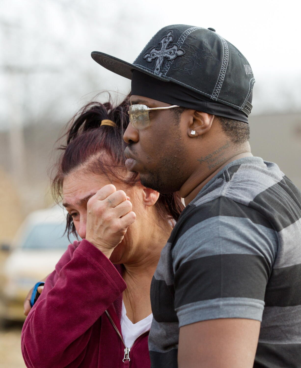 Kasmond Parker, right, consoles Cyndy Mann on Sunday at the crash site in Warren, Ohio.