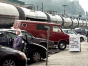 A mile-long train ambles down A Street in Rainier, Ore., loaded with oil from the Bakken oil fields in North Dakota in February.