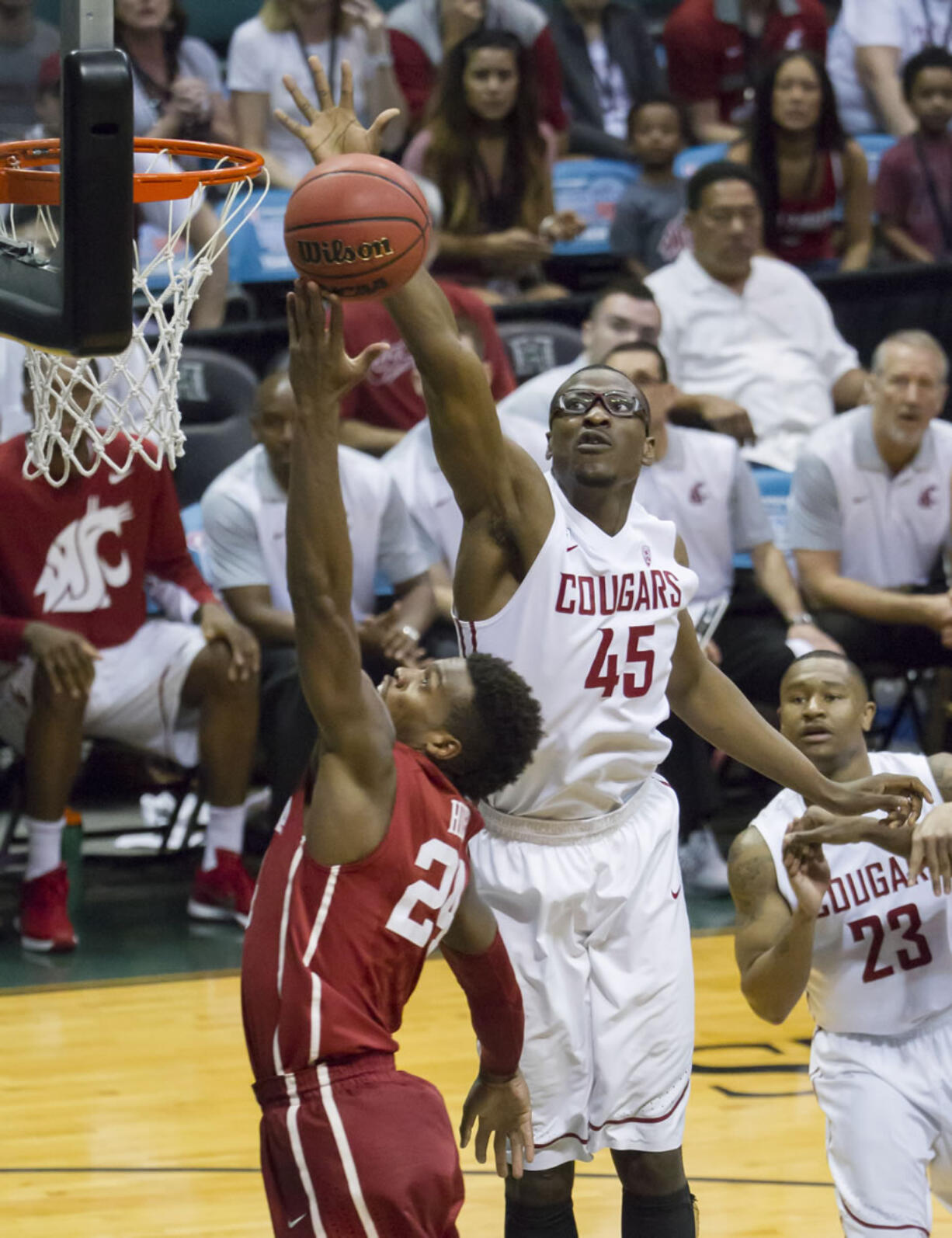 Washington State center Valentine Izundu (45) blocks the shot of Oklahoma guard Buddy Hield (24) duirng the first half of an NCAA college basketball game at the Diamond Head Classic, Tuesday, Dec. 22, 2015, in Honolulu.