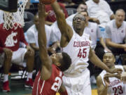 Washington State center Valentine Izundu (45) blocks the shot of Oklahoma guard Buddy Hield (24) duirng the first half of an NCAA college basketball game at the Diamond Head Classic, Tuesday, Dec. 22, 2015, in Honolulu.