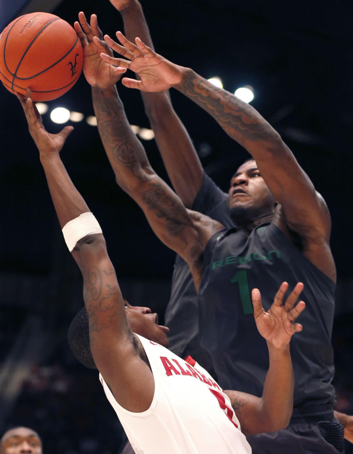 Oregon forward Jordan Bell (1) blocks the shot of Alabama guard Justin Coleman (5) during the second half of an NCAA college basketball game Monday, Dec. 21, 2015, in Birmingham, Ala. Oregon won 72-68.